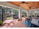 Covered patio with a wood plank ceiling, brick floor, ceiling fans, and outdoor seating at 3408 W San Jose St, Tampa, FL 33629