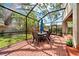 The brick patio is screened in with a dining table and seating, plus backyard views at 3408 W San Jose St, Tampa, FL 33629