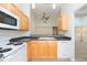 Kitchen with light wood cabinetry and breakfast bar overlooking an open living area at 3777 Mission Ct, Largo, FL 33771