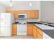 Bright kitchen featuring light wood cabinets, white appliances, and ample counter space at 3777 Mission Ct, Largo, FL 33771