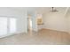 Bright living area with tile floors, ceiling fan, and an open layout to the kitchen at 3777 Mission Ct, Largo, FL 33771