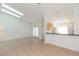 Open living area with tile flooring, high ceilings, and sliding doors to the outdoors at 3777 Mission Ct, Largo, FL 33771