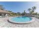 Relaxing swimming pool surrounded by plenty of chairs with a bathhouse nearby at 3777 Mission Ct, Largo, FL 33771