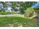 Lush green backyard, shaded by a large tree, providing an idyllic outdoor space at 39407 Rockford Ave, Zephyrhills, FL 33542