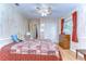 Bedroom with a bed, dresser, closet, and a window with natural light, vintage paneling at 39407 Rockford Ave, Zephyrhills, FL 33542