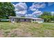The house features brick accents and a well-manicured lawn, creating a welcoming and charming curb appeal at 39407 Rockford Ave, Zephyrhills, FL 33542