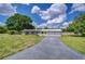 Charming single-story home features a two-car garage, brick accents, and a long driveway with a unique compass design at 39407 Rockford Ave, Zephyrhills, FL 33542