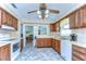 Cozy kitchen featuring wood cabinets, modern appliances, and adjacent living area at 39407 Rockford Ave, Zephyrhills, FL 33542