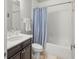 Bright bathroom featuring marble countertops and a bathtub with white and blue curtain at 4010 W Leona St, Tampa, FL 33629