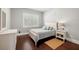 Cozy bedroom with white wood floors, window with blinds, and a comfortable full-size bed at 4010 W Leona St, Tampa, FL 33629