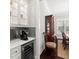 Butler pantry with a built-in wine fridge and coffee machine, connecting the dining room and kitchen at 4010 W Leona St, Tampa, FL 33629