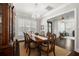 Well-lit dining room showcasing dark wood floors, a large hutch, a globe chandelier, and a glimpse into the living area at 4010 W Leona St, Tampa, FL 33629
