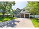 Charming two-story home boasting a well-manicured lawn, mature trees, and a brick-paved driveway at 4010 W Leona St, Tampa, FL 33629