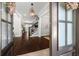 Inviting foyer with gleaming hardwood floors, elegant lighting, and a view of the staircase at 4010 W Leona St, Tampa, FL 33629