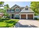 Charming two-story home with stone accents, well-manicured lawn, and a paved driveway at 4010 W Leona St, Tampa, FL 33629