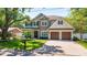 Beautiful two-story home with stone accents, manicured lawn, and a charming front porch at 4010 W Leona St, Tampa, FL 33629