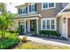 Welcoming front porch with seating, decorative wreaths, and lush landscaping at 4010 W Leona St, Tampa, FL 33629
