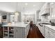 Open kitchen design with center island and marble countertops, stainless steel appliances, and pendant lighting at 4010 W Leona St, Tampa, FL 33629