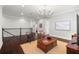 A view of the living area with hardwood floors, a chandelier, and large windows with shutters at 4010 W Leona St, Tampa, FL 33629