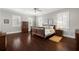 Spacious main bedroom with hardwood floors, plantation shutters, and decorative furnishings at 4010 W Leona St, Tampa, FL 33629