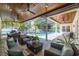 Relaxing screened-in patio featuring comfortable seating, ceiling fans, and a view of the pool area at 4010 W Leona St, Tampa, FL 33629