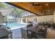 Covered pool with an outdoor dining table and barbeque overlooking the pool at 4010 W Leona St, Tampa, FL 33629