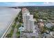 Breathtaking aerial view of a coastal high-rise building, highlighting its prime location near the beach and city at 4141 Bayshore Blvd # 306, Tampa, FL 33611