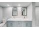 Modern bathroom featuring dual sinks, updated fixtures, gray cabinets and white countertop at 4141 Bayshore Blvd # 306, Tampa, FL 33611