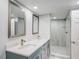 Updated bathroom features double sink vanity, mirrors, and a glass enclosed shower at 4141 Bayshore Blvd # 306, Tampa, FL 33611