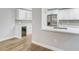 Kitchen with stainless steel appliances, wine cooler, white cabinetry and backsplash tiling at 4141 Bayshore Blvd # 306, Tampa, FL 33611