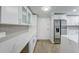 Elegant kitchen with white cabinetry, a stainless steel refrigerator, and a stylish backsplash, creating a sophisticated look at 4141 Bayshore Blvd # 306, Tampa, FL 33611