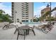 Upscale outdoor pool area with cushioned lounge chairs, tables and manicured landscaping at 4141 Bayshore Blvd # 306, Tampa, FL 33611