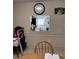 Dining area view showing the clock on the wall and view to the kitchen at 4217 Tamargo Dr # A, New Port Richey, FL 34652