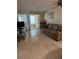 Bright living room featuring tile floors, a comfortable couch, and sliding doors to the enclosed patio at 4217 Tamargo Dr # A, New Port Richey, FL 34652