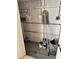 Image of a storage area inside the house with exposed plumbing and cleaning supplies at 4217 Tamargo Dr # A, New Port Richey, FL 34652