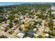 Aerial view depicting the home in a mature treed neighborhood with water in the distance at 4527 24Th S Ave, St Petersburg, FL 33711