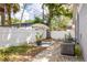 A quaint backyard featuring a stone pathway, a decorative shade umbrella, and an air conditioning unit at 4527 24Th S Ave, St Petersburg, FL 33711