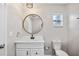 Compact bathroom with a white vanity, round mirror, and modern fixtures at 4527 24Th S Ave, St Petersburg, FL 33711
