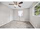 Comfortable bedroom features plush carpeting, ceiling fan and ample natural light from the window at 4527 24Th S Ave, St Petersburg, FL 33711