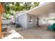 Exterior view featuring a covered patio with chairs and a meticulously designed rock garden at 4527 24Th S Ave, St Petersburg, FL 33711