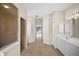 Spacious bathroom with tiled floors, walk-in shower, and vanity, offering a clean and functional design at 4538 Appleton Ter, North Port, FL 34286