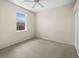 Neutral bedroom with a window, ceiling fan, and closet at 4538 Appleton Ter, North Port, FL 34286
