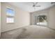 Bedroom with sliding door access to the screened lanai and pool and a large window for natural light at 4538 Appleton Ter, North Port, FL 34286
