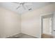 A bright bedroom with an open doorway, carpeted floor, and a ceiling fan at 4538 Appleton Ter, North Port, FL 34286