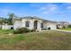 Inviting home featuring an attached two-car garage and complemented by lush landscaping at 4538 Appleton Ter, North Port, FL 34286