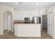 Spacious kitchen boasts white cabinets, stainless steel appliances, breakfast bar, and seamless flow to the adjacent rooms at 4538 Appleton Ter, North Port, FL 34286