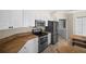 A kitchen featuring white cabinets, stainless steel appliances, and a view into the utility room at 4538 Appleton Ter, North Port, FL 34286