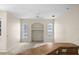 Inviting living area showcasing arched windows, a built-in niche, and neutral tones, perfect for relaxation and entertainment at 4538 Appleton Ter, North Port, FL 34286
