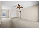 Spacious living room with tile and carpet floors, a ceiling fan, and a front-facing window at 4538 Appleton Ter, North Port, FL 34286