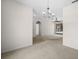 The open-concept living room features tile and carpet flooring, an overhead chandelier, and ample natural light at 4538 Appleton Ter, North Port, FL 34286